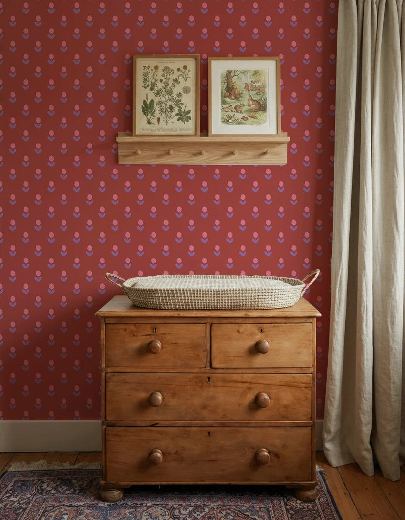Bloemen Rood – Atelier Chien: behang achter een houten commode met verschoonmand.